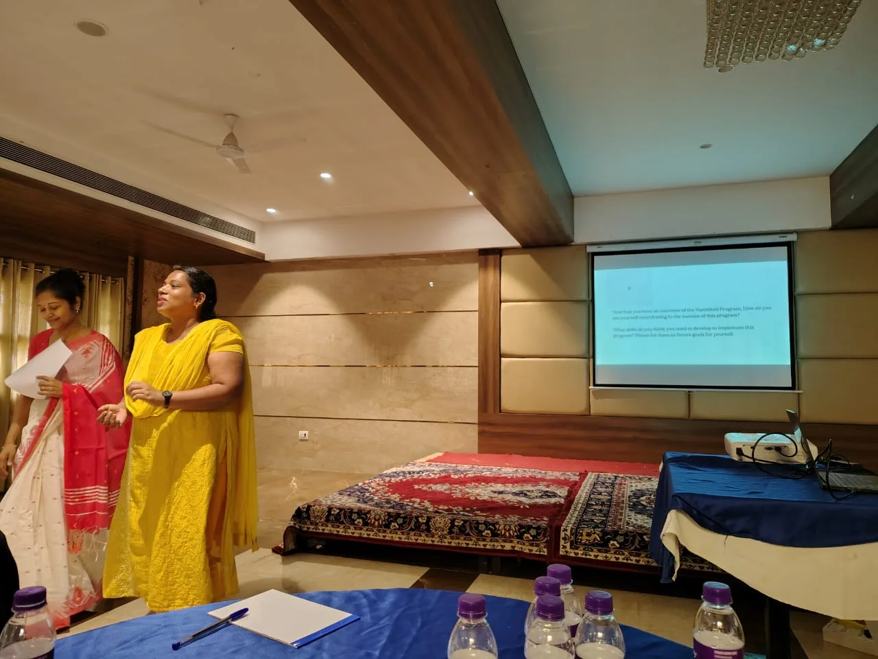 Mrs. Rita Marshall presenting at a corporate training session in a conference hall setting
